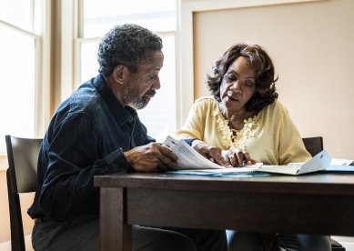 Couple looking at documents on table.